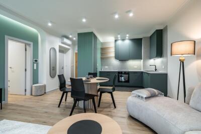 Modern pastel kitchen with designer lighting.