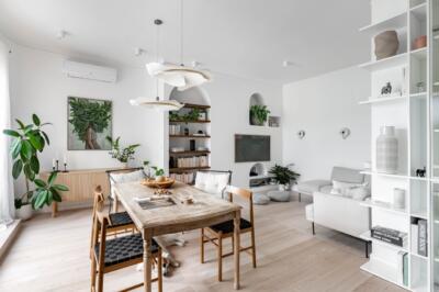 Bright living room with natural wood and green plants.