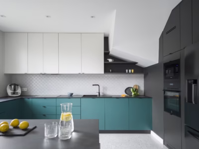 Modern kitchen with turquoise cabinets and white tiles.
