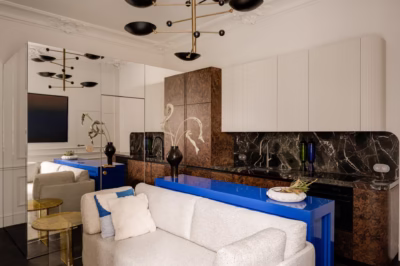Stylish living room with a blue countertop, patterned marble and gold accents.